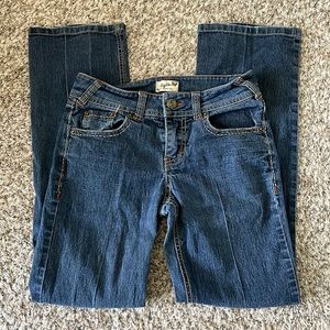 Tyte denim jeans with elongating front detail and heart back pocket details.